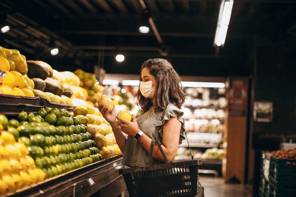 Checking quiet price hikes as a shopper compares produce prices while grocery shopping.