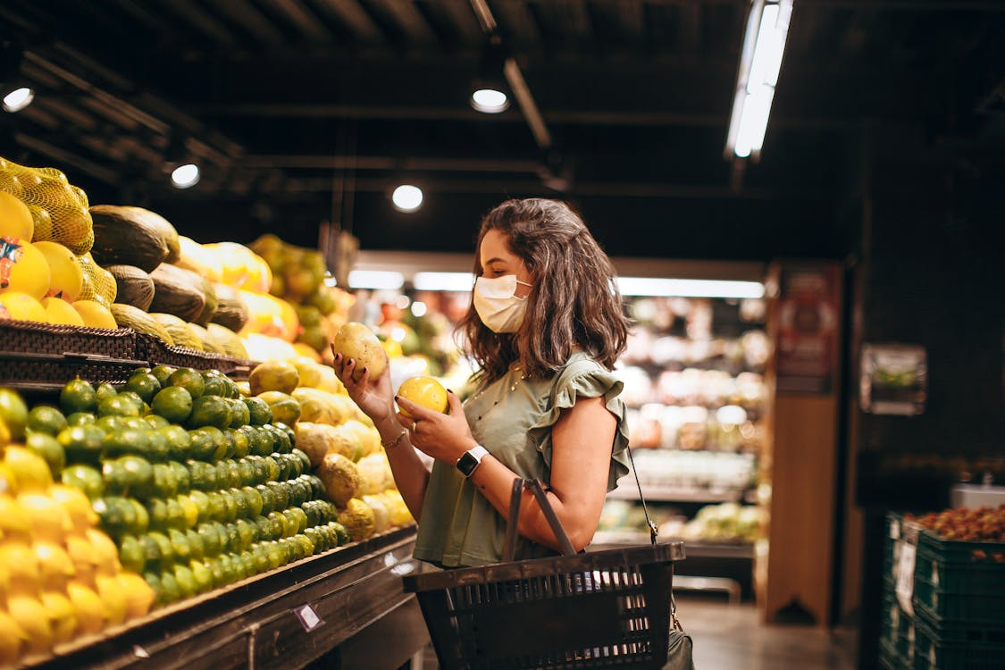 Checking quiet price hikes as a shopper compares produce prices while grocery shopping.